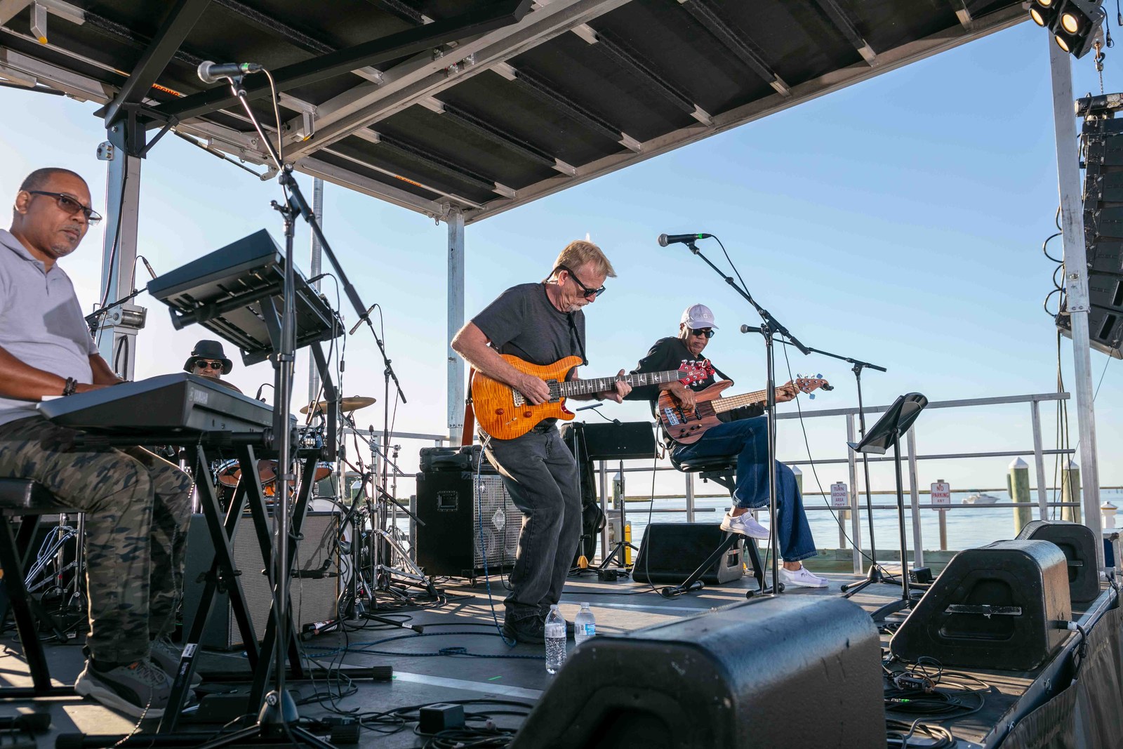 Guitarists performing on the outdoor stage