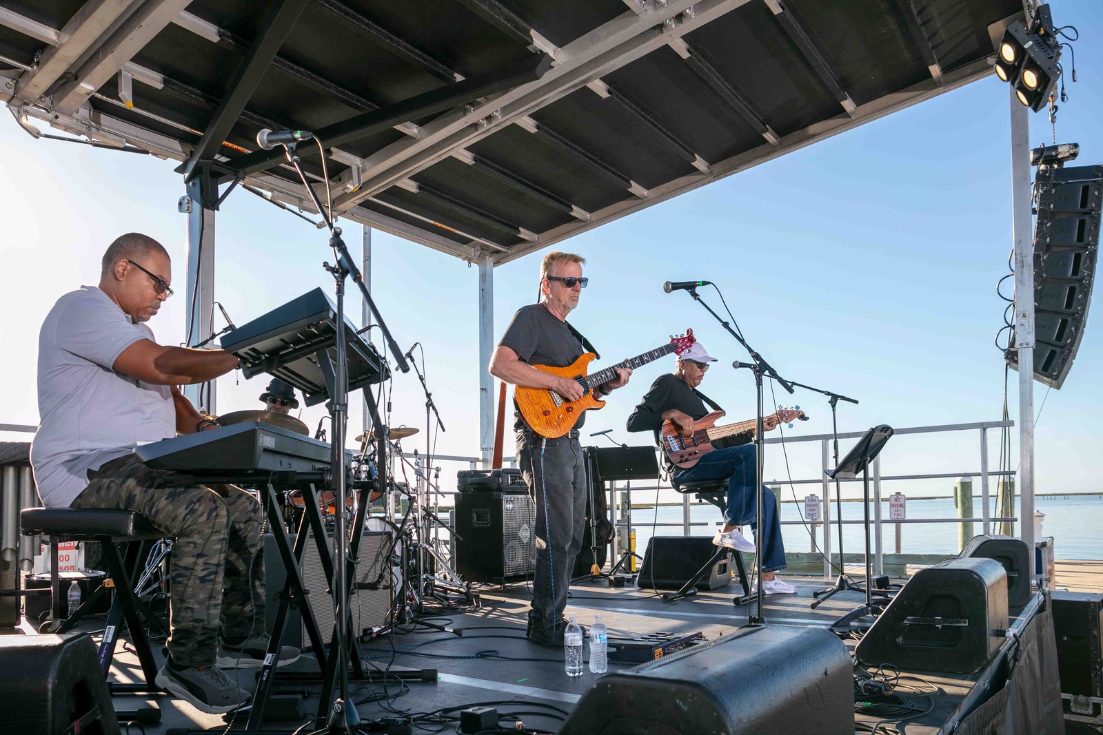 The band performing beside the water