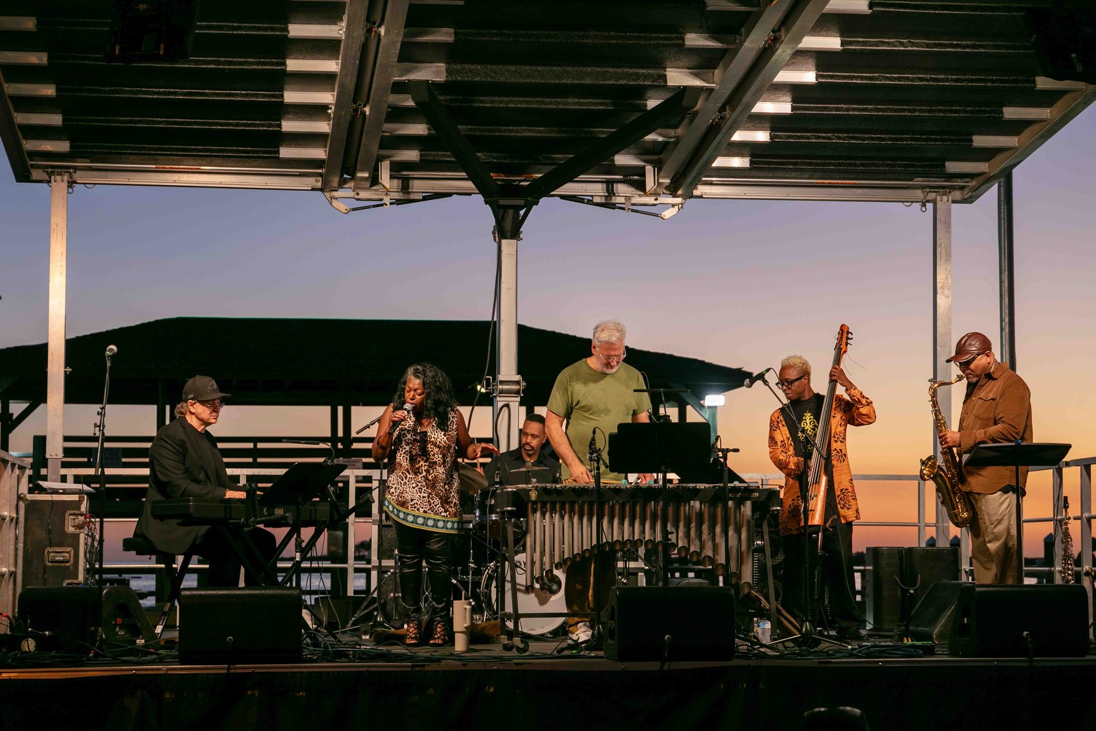 Musicians silhouetted by the evening sky