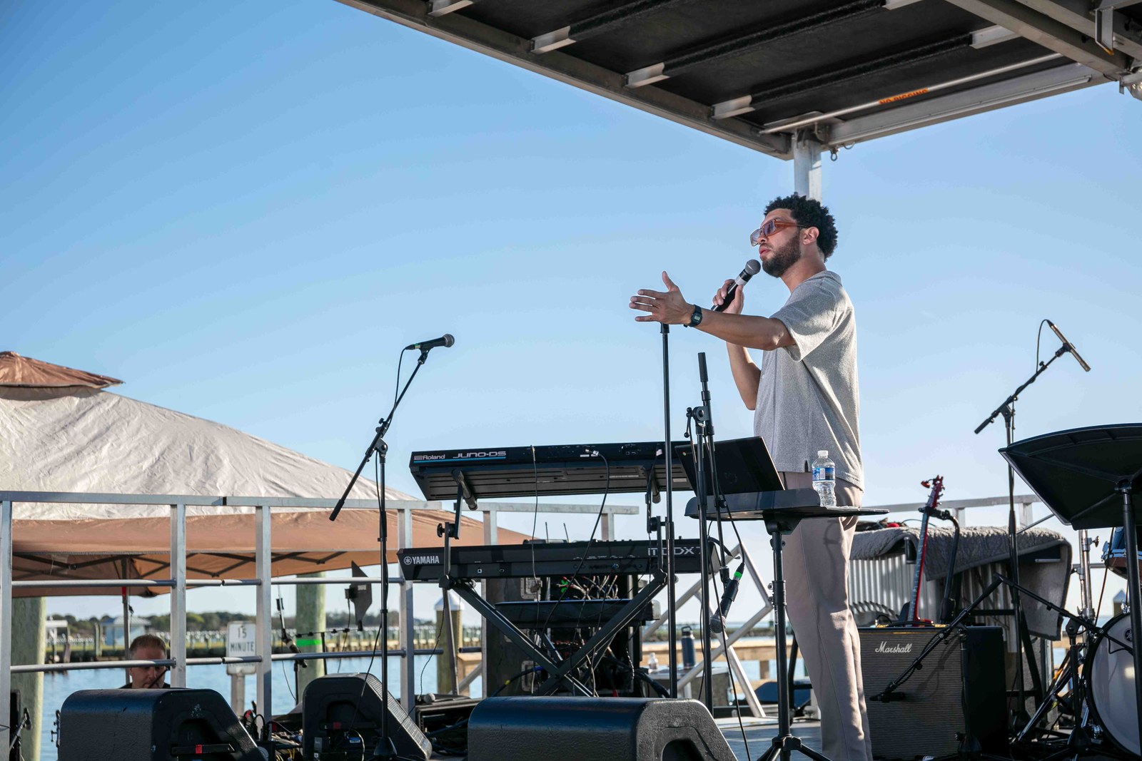 The vocalist performing beside the water