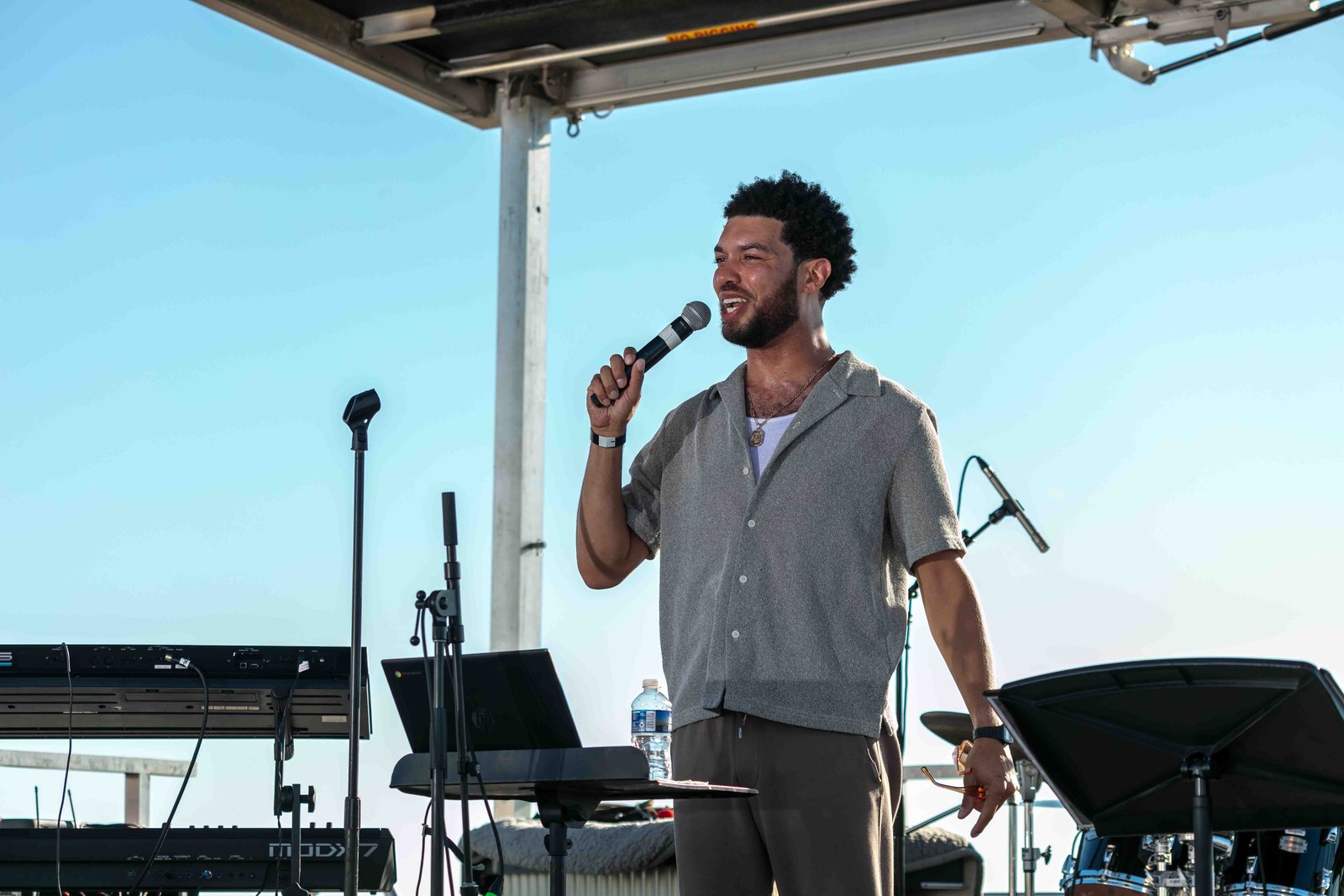 The vocalist singing into a handheld microphone